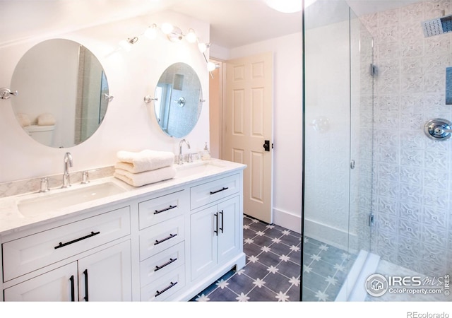 1114 5th Ave, Longmont, CO 80501 - bathroom with double vanity, tile patterned floors, a shower stall, and a sink