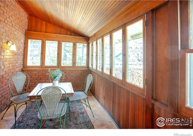 1114 5th Ave, Longmont, CO 80501 - sunroom with wooden ceiling, vaulted ceiling, wood walls, and brick wall