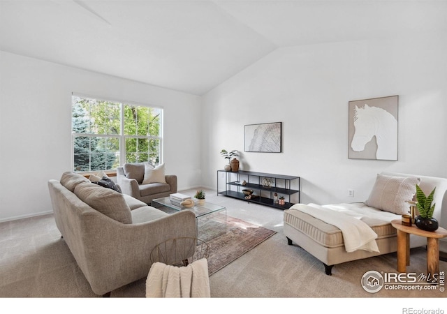 carpeted living room with lofted ceiling