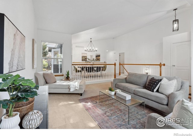 carpeted living area with a chandelier and lofted ceiling