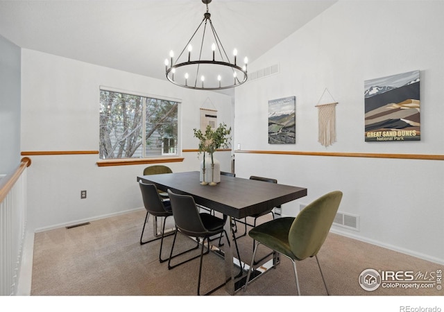 carpeted dining room with visible vents, baseboards, lofted ceiling, and an inviting chandelier