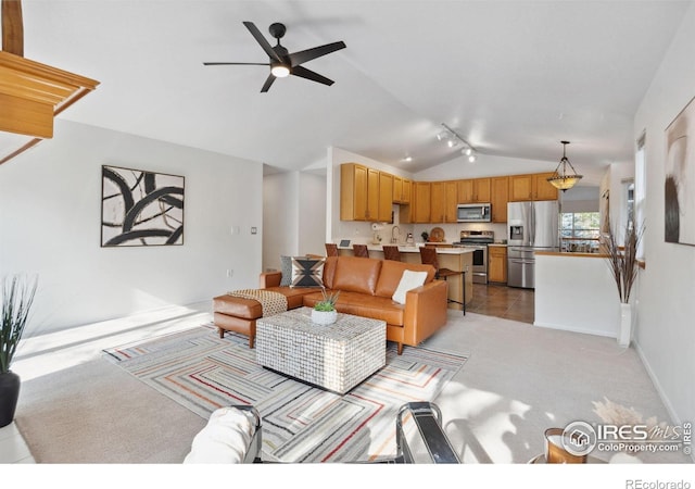 living room featuring baseboards, ceiling fan, vaulted ceiling, and light carpet