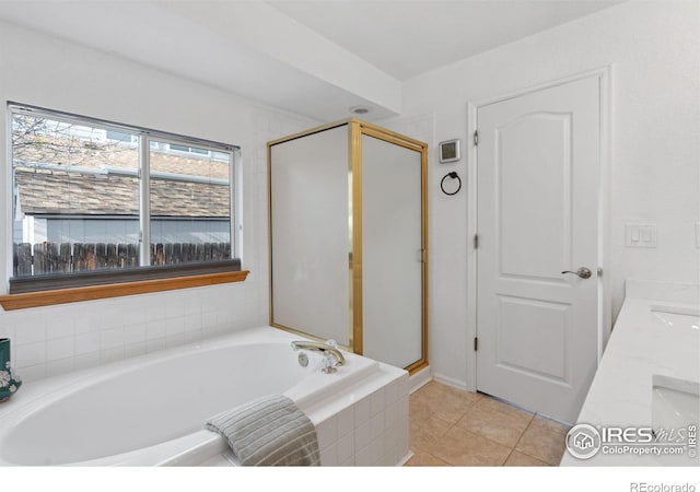 bathroom featuring a stall shower, a bath, and tile patterned floors