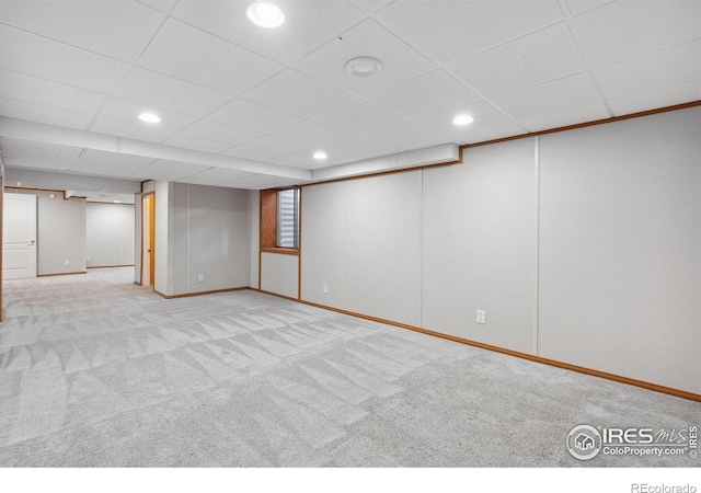 finished basement with carpet flooring, recessed lighting, baseboards, and a drop ceiling