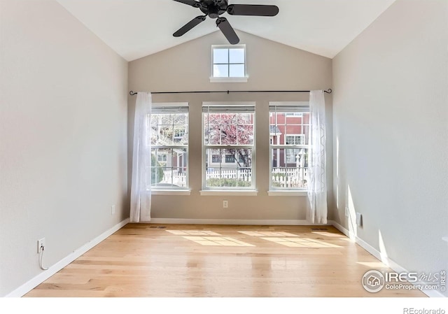 unfurnished room featuring baseboards, ceiling fan, wood finished floors, and lofted ceiling