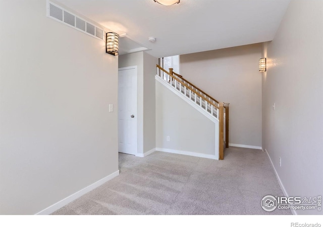 interior space with baseboards, carpet flooring, stairs, and visible vents
