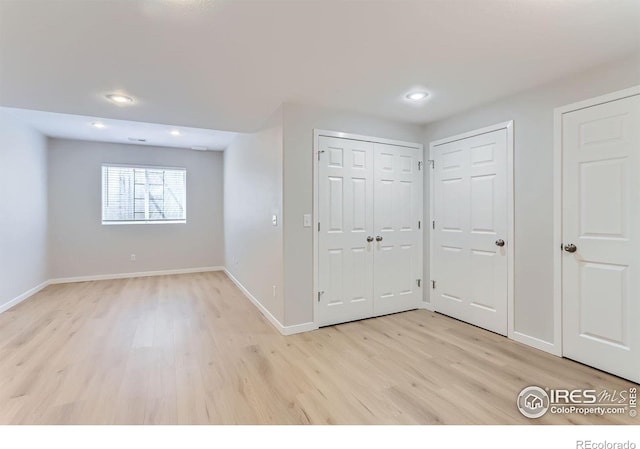 interior space with baseboards, recessed lighting, and light wood-style flooring
