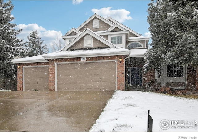 craftsman-style house featuring brick siding and concrete driveway