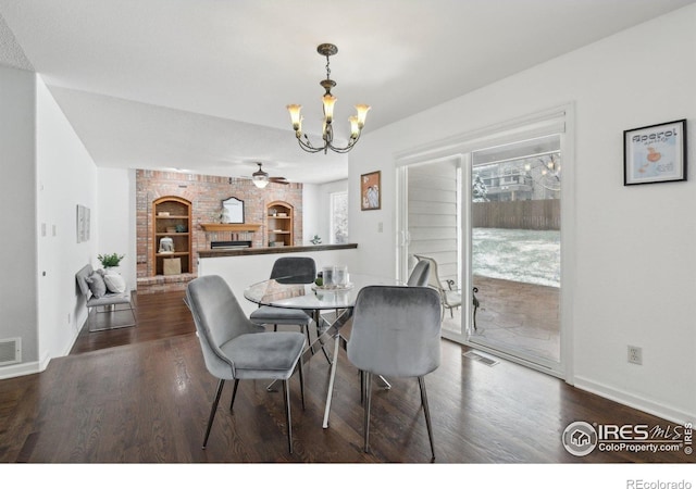 dining room featuring baseboards, visible vents, dark wood finished floors, and ceiling fan with notable chandelier
