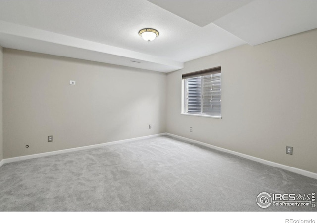carpeted empty room with baseboards
