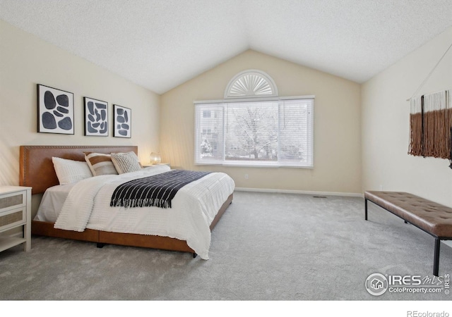 carpeted bedroom with baseboards and vaulted ceiling