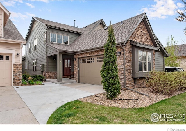 craftsman house with a garage, driveway, stone siding, and a shingled roof
