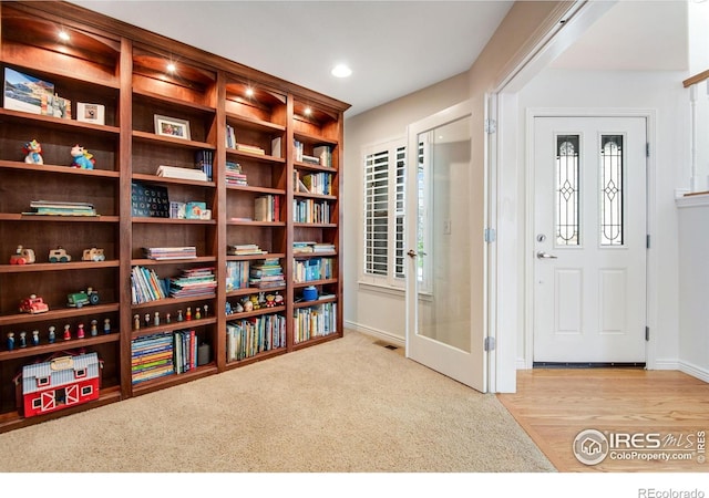 living area featuring baseboards, recessed lighting, and visible vents