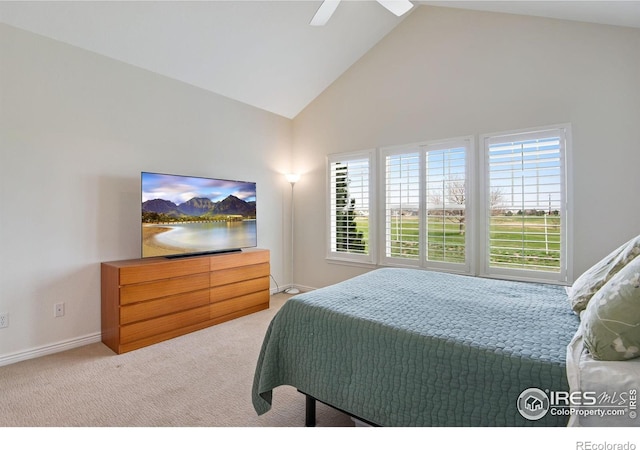 carpeted bedroom featuring baseboards, ceiling fan, and high vaulted ceiling