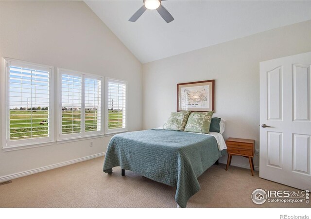 bedroom with baseboards, ceiling fan, carpet flooring, and high vaulted ceiling