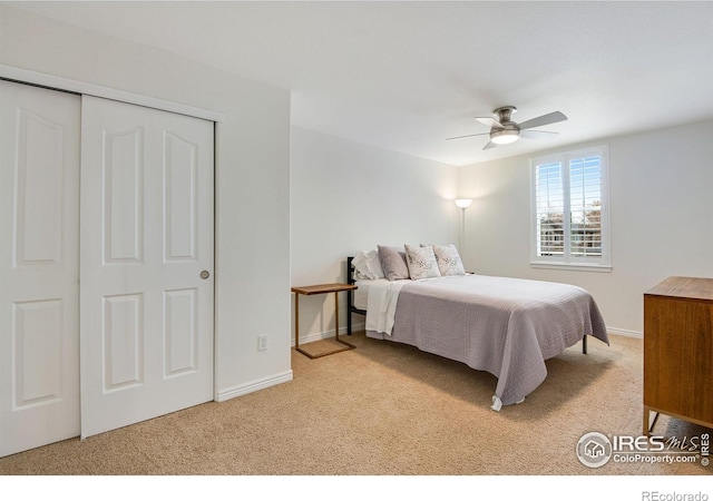 carpeted bedroom featuring baseboards, ceiling fan, and a closet