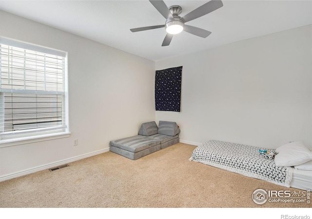 unfurnished bedroom featuring carpet floors, baseboards, and multiple windows