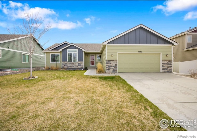 7056 Langland St, Wellington, CO 80549 - craftsman-style home with stone siding, board and batten siding, an attached garage, and concrete driveway