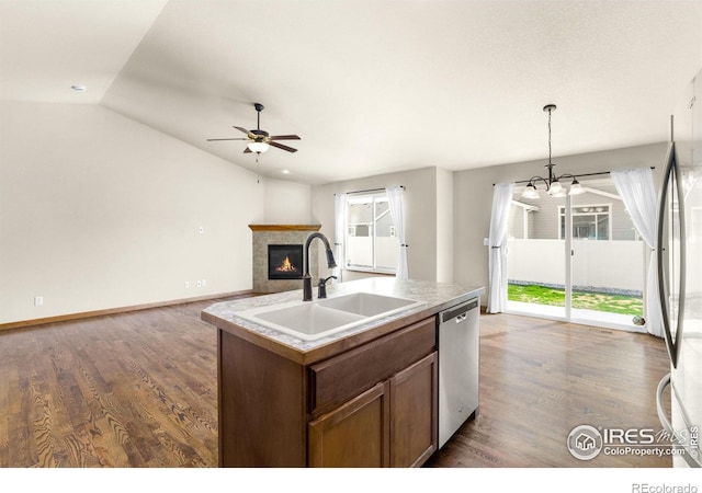 7056 Langland St, Wellington, CO 80549 - kitchen featuring stainless steel appliances, a ceiling fan, a sink, a fireplace, and dark wood finished floors