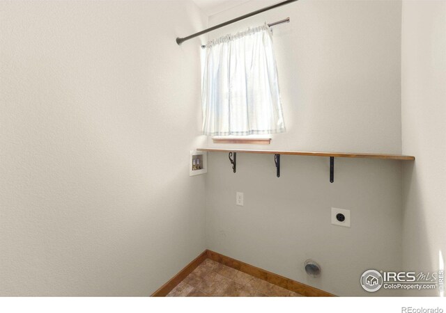 7056 Langland St, Wellington, CO 80549 - clothes washing area featuring washer hookup, baseboards, hookup for an electric dryer, and tile patterned flooring