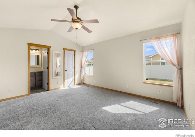 7056 Langland St, Wellington, CO 80549 - unfurnished bedroom with lofted ceiling, baseboards, carpet flooring, and connected bathroom