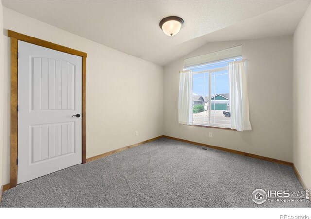 7056 Langland St, Wellington, CO 80549 - carpeted spare room with lofted ceiling and baseboards