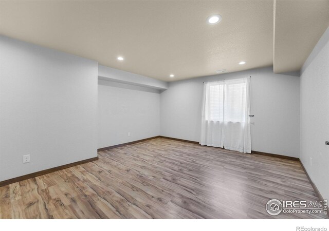 7056 Langland St, Wellington, CO 80549 - basement with wood finished floors, baseboards, and recessed lighting