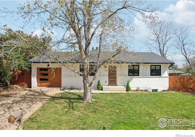 single story home featuring a garage, a front lawn, fence, brick siding, and concrete driveway