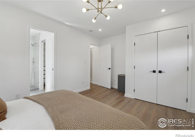 bedroom featuring a closet, recessed lighting, wood finished floors, and a notable chandelier