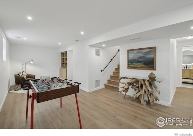 game room with baseboards, visible vents, and light wood-style floors