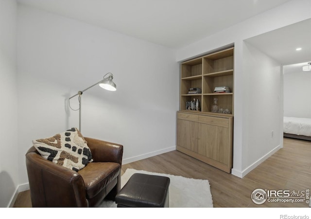 living area with light wood-style floors and baseboards