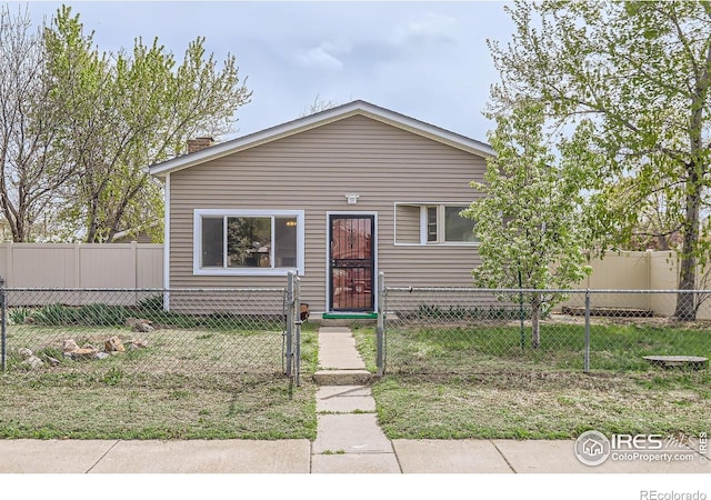 214 2nd St, Frederick, CO 80530 - bungalow-style home with a fenced front yard and a chimney