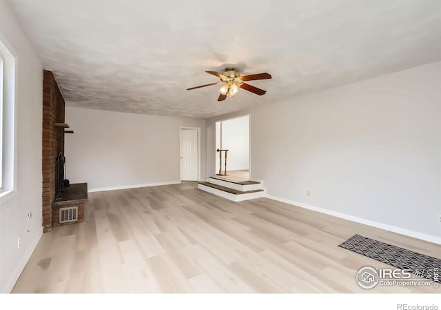 214 2nd St, Frederick, CO 80530 - unfurnished living room featuring baseboards, light wood finished floors, ceiling fan, and visible vents