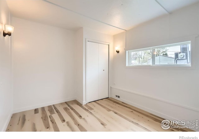 214 2nd St, Frederick, CO 80530 - bonus room with light wood finished floors, visible vents, and baseboards