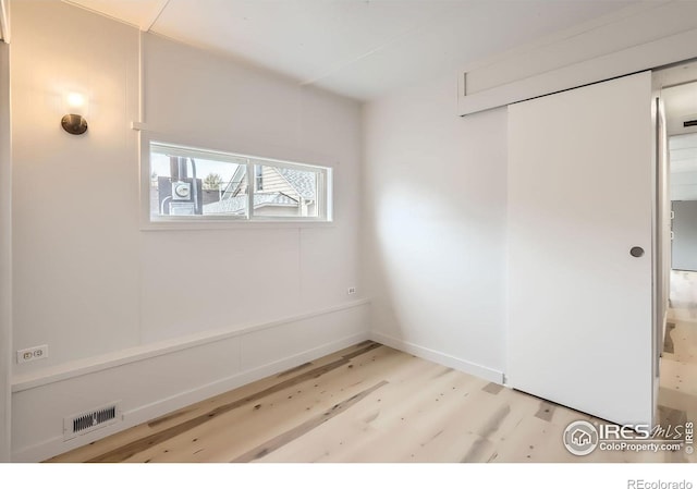 214 2nd St, Frederick, CO 80530 - empty room with visible vents, wood finished floors, and baseboards