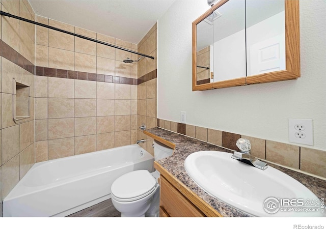 bathroom featuring vanity, toilet, and tub / shower combination
