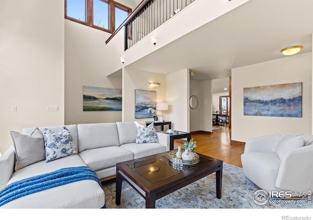 2499 Powderhorn Ln, Boulder, CO 80305 - living room featuring baseboards, wood finished floors, and a towering ceiling