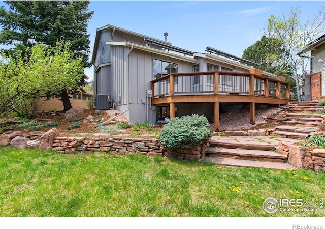 2499 Powderhorn Ln, Boulder, CO 80305 - rear view of property featuring central air condition unit, a wooden deck, and a lawn