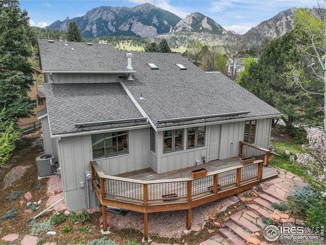 2499 Powderhorn Ln, Boulder, CO 80305 - back of house featuring board and batten siding, a deck with mountain view, a shingled roof, and central air condition unit