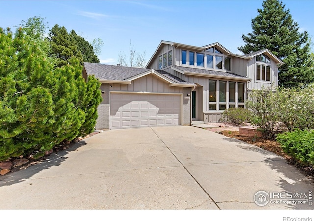 2499 Powderhorn Ln, Boulder, CO 80305 - view of front of home with an attached garage, a shingled roof, board and batten siding, and concrete driveway