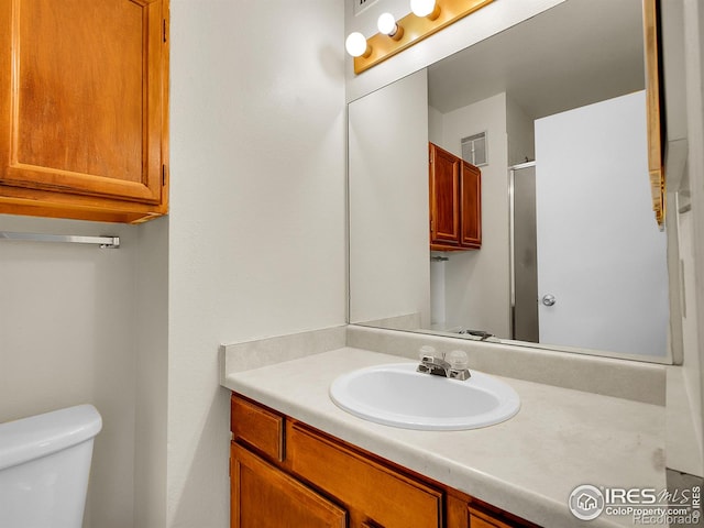 1094 S Dearborn St Unit 301, Aurora, CO 80012 - bathroom featuring vanity, toilet, and a shower