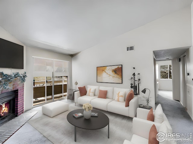 1094 S Dearborn St Unit 301, Aurora, CO 80012 - carpeted living area featuring a brick fireplace and lofted ceiling