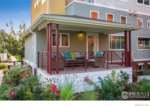 exterior space featuring a porch and stucco siding