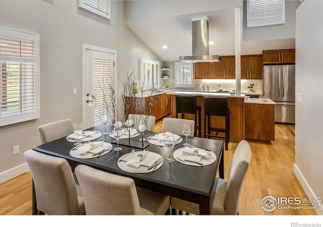 dining space with light wood-style floors, baseboards, and visible vents