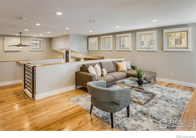living area featuring baseboards, recessed lighting, wood finished floors, and visible vents