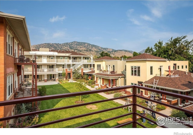 balcony featuring a residential view and a mountain view