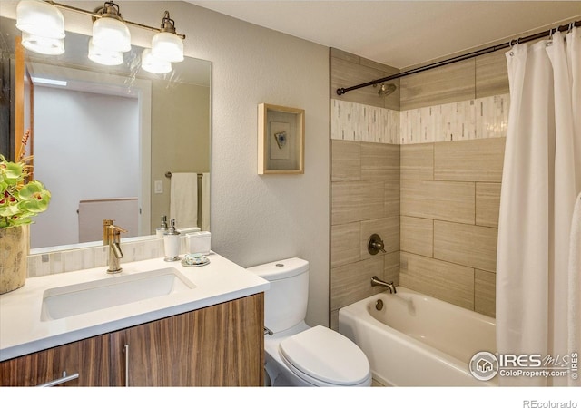 full bath featuring vanity, shower / tub combo, a textured wall, and toilet