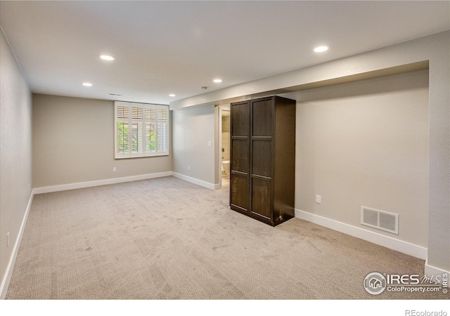 basement featuring visible vents, recessed lighting, baseboards, and light carpet