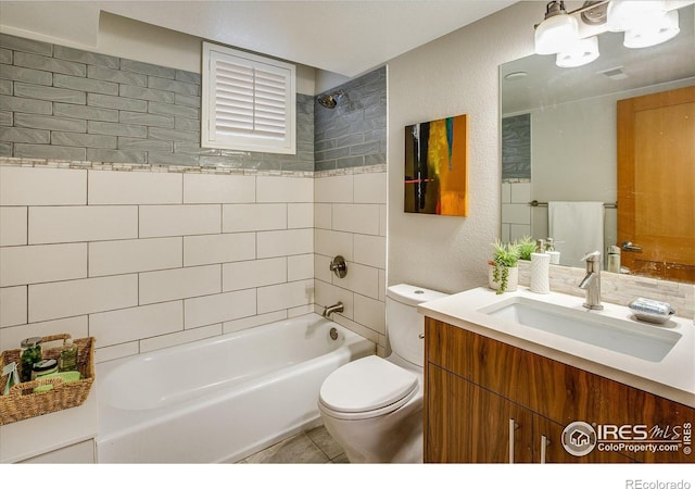 bathroom featuring a textured wall, vanity, toilet, tile patterned floors, and shower / bathing tub combination