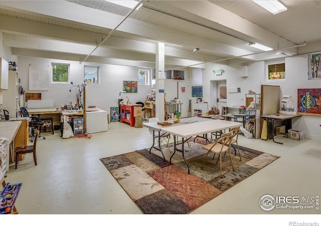 dining space featuring concrete flooring and beam ceiling